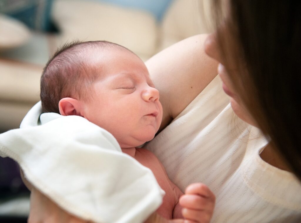 newborn baby in mothers arms